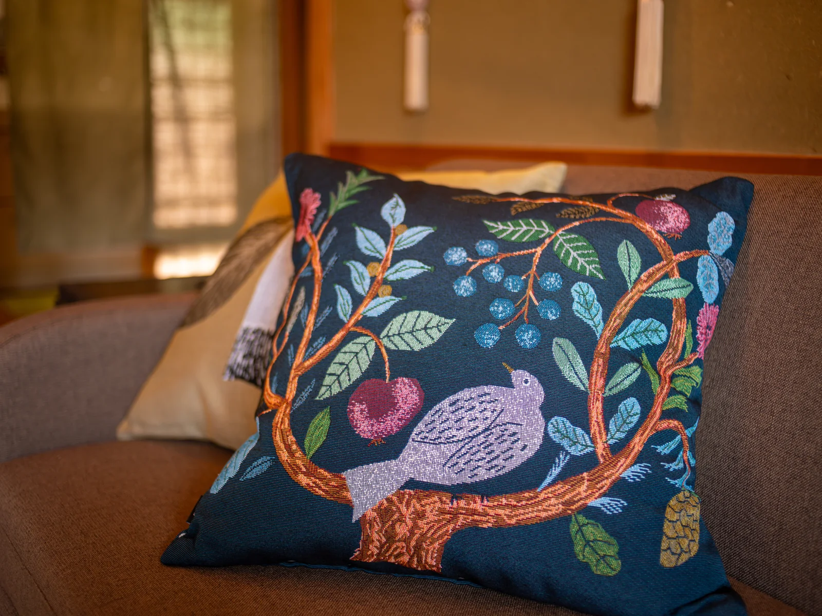 Cushion with embroidered birds